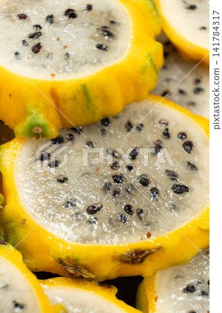 Exotic tropical fruit background with round dragon fruit pitaya slices Exotic tropical fruit background with round dragon fruit pitaya slices 141784317