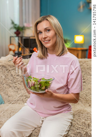 Pregnant woman eating fresh cabbage tomato salad showing healthy vitamin nutrition during pregnancy Pregnant woman eating fresh cabbage tomato salad showing healthy vitamin nutrition during pregnancy 141785798