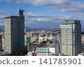 The view from in front of Sendai Station, with city skyscrapers and mountains in the background. 141785901
