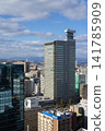 A view from in front of Sendai Station, with city buildings and a blue sky. 141785909