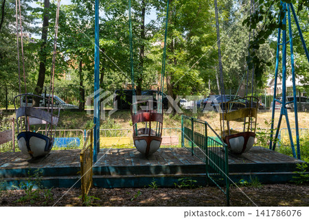 Old Abandoned Boat Swing Ride in City Park 141786076