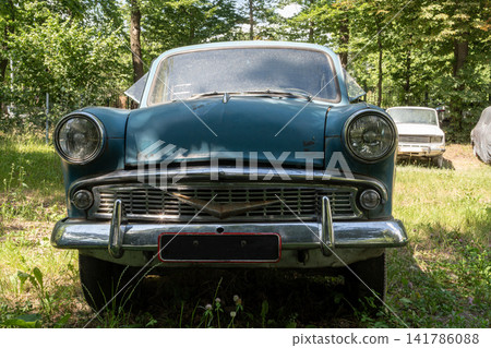 Front View of Vintage Blue Soviet Automobile Parked on Green Grass Front View of Vintage Blue Soviet Automobile Parked on Green Grass 141786088