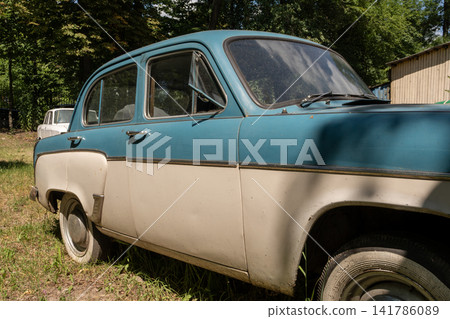 Side Profile of Two Tone Vintage Soviet Car Parked Outdoors Side Profile of Two Tone Vintage Soviet Car Parked Outdoors 141786089