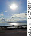 A seaside road overlooking the sparkling sea and distant mountains. A seaside road overlooking the sparkling sea and distant mountains. 141786544