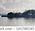Coastal facilities standing by the calm waters and the clouds spreading out. Coastal facilities standing by the calm waters and the clouds spreading out. 141786545