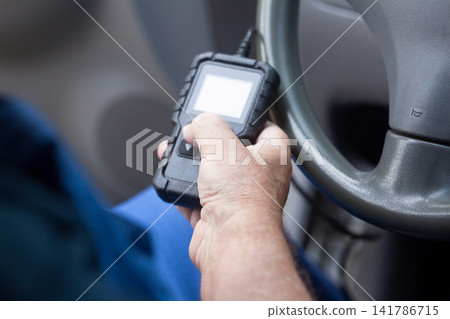 Man using car diagnostic scan tool Man using car diagnostic scan tool 141786715