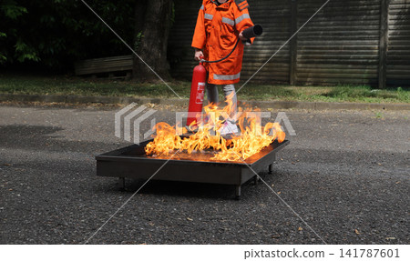 fire prevention. corporate safety - exercise during a firefighting course fire prevention. corporate safety - exercise during a firefighting course 141787601