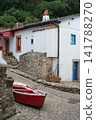 Traditional house and red fishing boat at Tazones, Asturias, Spain 141788270