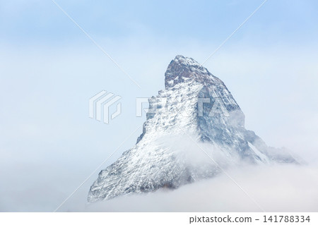 Matterhorn Swiss Alps Switzerland iconic snowy pyramid mountain peak, fog clouds Matterhorn Swiss Alps Switzerland iconic snowy pyramid mountain peak, fog clouds 141788334