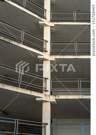 Empty Multi-Level Parking Garage With Concrete Slabs and Metal Railings, Urban Architectural Detail Empty Multi-Level Parking Garage With Concrete Slabs and Metal Railings, Urban Architectural Detail 141788465