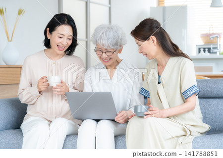 A senior female friend who uses her computer at home. A senior female friend who uses her computer at home. 141788851