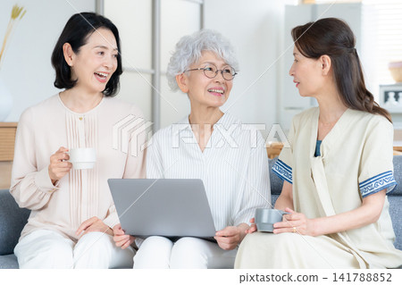 A senior female friend who uses her computer at home. A senior female friend who uses her computer at home. 141788852