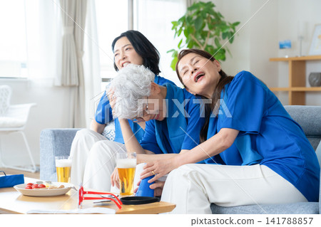 A senior female friend who watches soccer at home A senior female friend who watches soccer at home 141788857