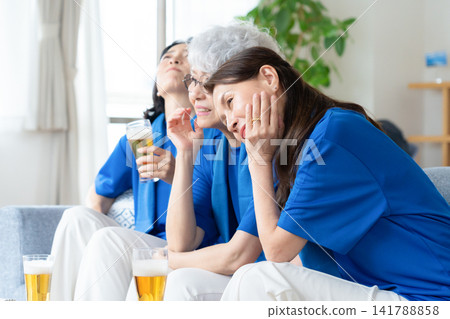 A senior female friend who watches soccer at home A senior female friend who watches soccer at home 141788858