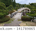 The Taiko Bridge and Stone Bridge at Sankei-en Garden: A picturesque summer scene in a Japanese garden. 141789865