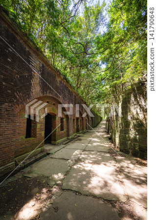 The brick fortress ruins and sunlight filtering through the trees at the site of the Third Battery on Tomogashima Island The brick fortress ruins and sunlight filtering through the trees at the site of the Third Battery on Tomogashima Island 141790648