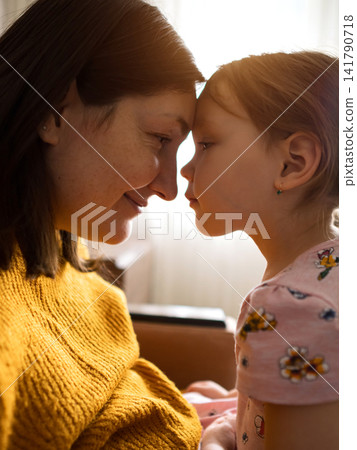 Mother and daughter foreheads touching sharing tender Mother and daughter foreheads touching sharing tender 141790718