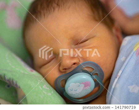 Newborn baby sleeping peacefully with pacifier Newborn baby sleeping peacefully with pacifier 141790719