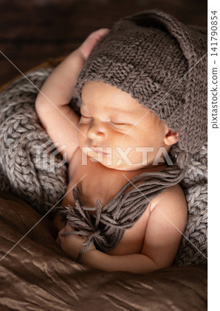 Newborn baby sleeping peacefully with knitted hat and blanket Newborn baby sleeping peacefully with knitted hat and blanket 141790854