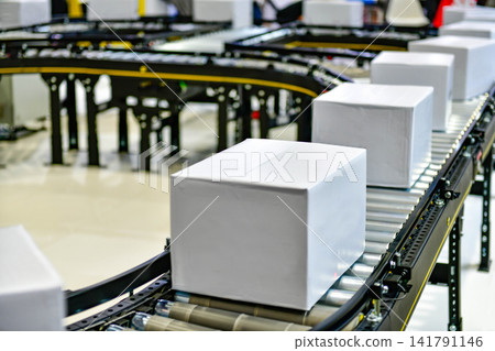 Automated conveyor belt system transporting blank white cardboard boxes in modern fulfillment warehouse logistics center 141791146
