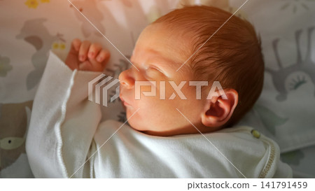Newborn baby sleeping peacefully on a patterned blanket Newborn baby sleeping peacefully on a patterned blanket 141791459