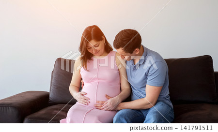 Pregnant woman and husband awaiting baby, touching belly Pregnant woman and husband awaiting baby, touching belly 141791511