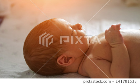 Newborn baby feeling warm sunlight on delicate skin Newborn baby feeling warm sunlight on delicate skin 141791533