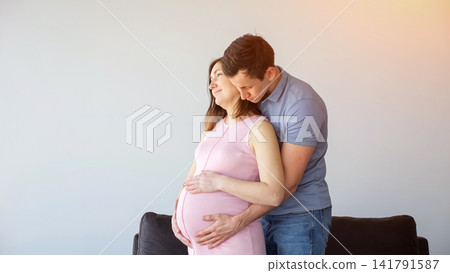 Expecting parents embracing, anticipating new baby and family life Expecting parents embracing, anticipating new baby and family life 141791587