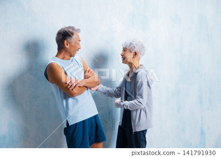 A lively senior couple doing stretches A lively senior couple doing stretches 141791930