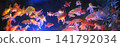 A vibrant school of goldfish swimming gracefully in a dark aquarium. This underwater scene captures the movement and beauty of aquatic life, perfect for nature themes, interior decor, or concepts. 141792034