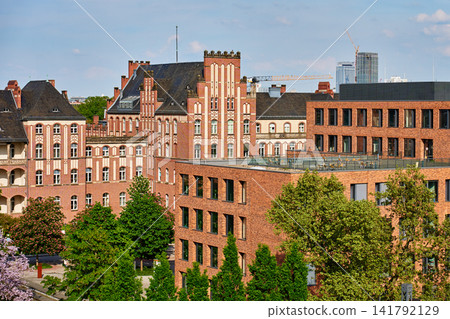 Historic red brick building beside modern city architecture 141792129