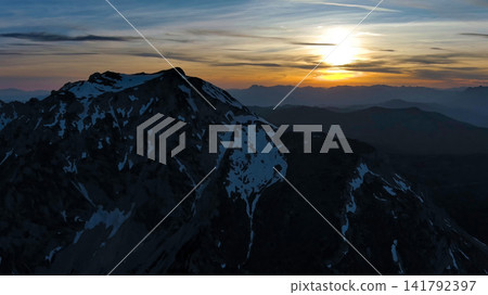 Rocky snow mountains at sunset aerial Rocky snow mountains at sunset aerial 141792397