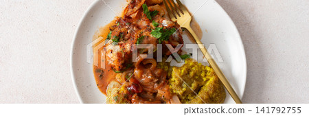Servings of porridge mix with amaranth, millet, and quinoa sit next to baked white hake covered in tomato sauce. This meal is healthy and gluten-free, banner Servings of porridge mix with amaranth, millet, and quinoa sit next to baked white hake covered in tomato sauce. This meal is healthy and gluten-free, banner 141792755
