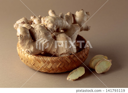 Ginger root on a beige background. Ginger root on a beige background. 141793119
