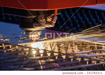 Sparkling light and sparks from fiber laser cutting machine engraving metal plate 141793311