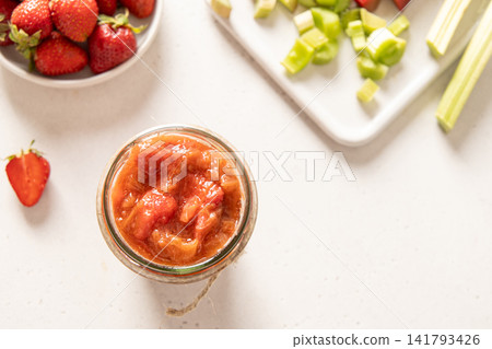 Top view homemade strawberry rhubarb jam with fresh ingredients Top view homemade strawberry rhubarb jam with fresh ingredients 141793426