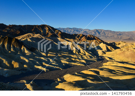 The erosional landscape of Zabriskie Point illuminated by the morning light. The erosional landscape of Zabriskie Point illuminated by the morning light. 141793456