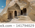 Close up view of ancient historic cave dwellings and rooms carved into volcanic tuff rock in Cappadocia, Turkey on sunny day 141794029