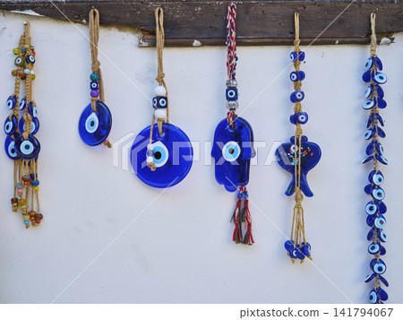 evil eye beads hanging on the wall 141794067