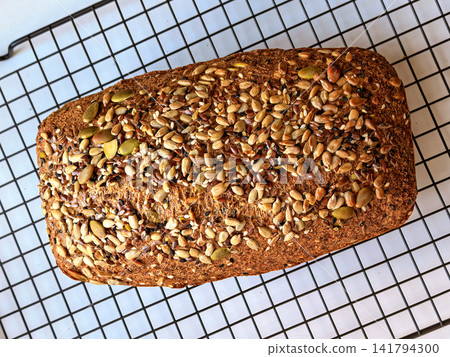 Whole Seeded Keto Bread Cooling On Wire Rack Whole Seeded Keto Bread Cooling On Wire Rack 141794300