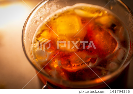 Glass cup ice cube special photo, cup wall water bead condensation, floating ice mass or amber translucent texture Glass cup ice cube special photo, cup wall water bead condensation, floating ice mass or amber translucent texture 141794356