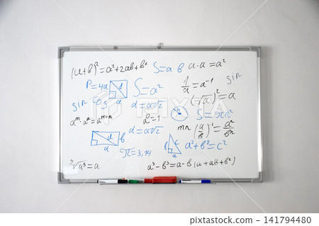 Whiteboard with handwritten mathematical formulas and geometric equations on a white wall Whiteboard with handwritten mathematical formulas and geometric equations on a white wall 141794480