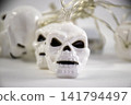 Halloween decoration white plastic skull string lights close up 141794497