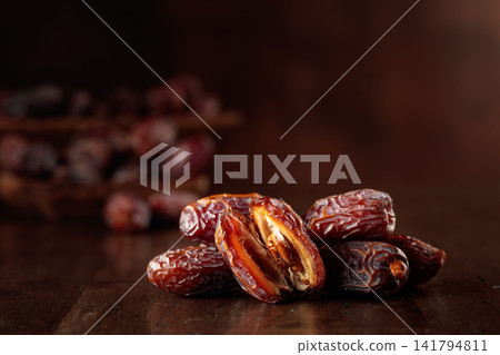 Dates fruit on an old wooden table. Dates fruit on an old wooden table. 141794811