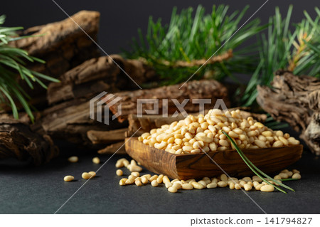 Peeled pine nuts with cedar dried snags and green branches. Peeled pine nuts with cedar dried snags and green branches. 141794827