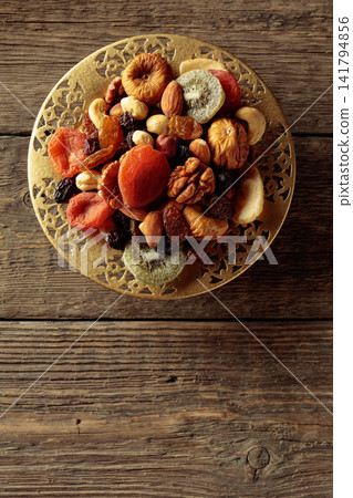 Assortment of dried tropical fruits, nuts and raisins. Assortment of dried tropical fruits, nuts and raisins. 141794856