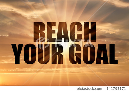 Reach your goal concept glowing on golden sunset sky Reach your goal concept glowing on golden sunset sky 141795171