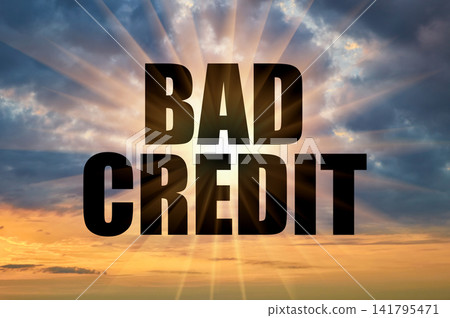 Bad credit conceptual phrase on a dramatic cloudy evening sky Bad credit conceptual phrase on a dramatic cloudy evening sky 141795471