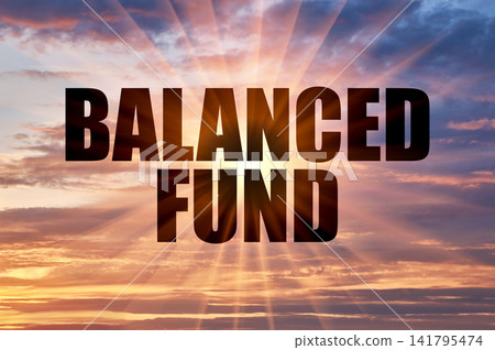 Balanced fund conceptual phrase on a purple and golden evening sky Balanced fund conceptual phrase on a purple and golden evening sky 141795474