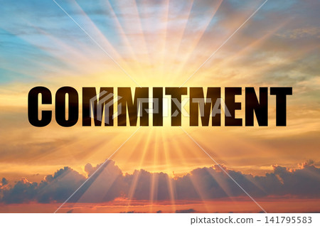 Commitment conceptual word on a beautiful colorful glowing sky with sun rays 141795583